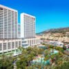 Meliá Benidorm lagoon-style swimming pool surrounded by tropical gardens and palm trees in Benidorm Spain