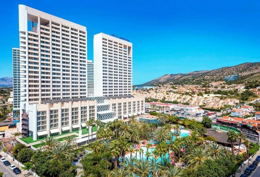 Meliá Benidorm lagoon-style swimming pool surrounded by tropical gardens and palm trees in Benidorm Spain